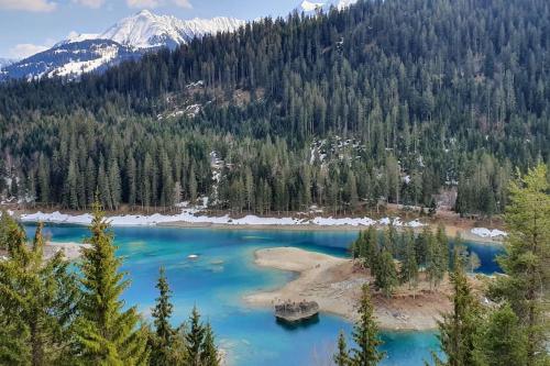 a view of a blue lake with mountains in the background at Flims 2 Room Apartment in Center Ski in-out TrulloVista in Flims