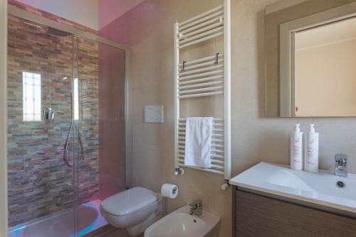a bathroom with a toilet and a sink and a shower at Casa Torre di Specchio 2 con Piscina in Bari