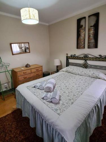 a bedroom with a teddy bear sitting on a bed at H(a)ver as Faias in Manteigas