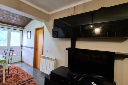 TV a/nebo společenská místnost v ubytování H(a)ver as Faias