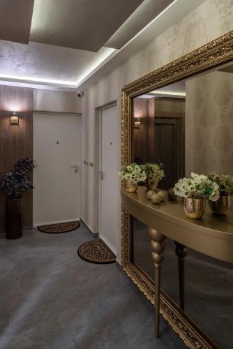 a hallway with a mirror and a table with flowers at Star32 in Vračar (historical)