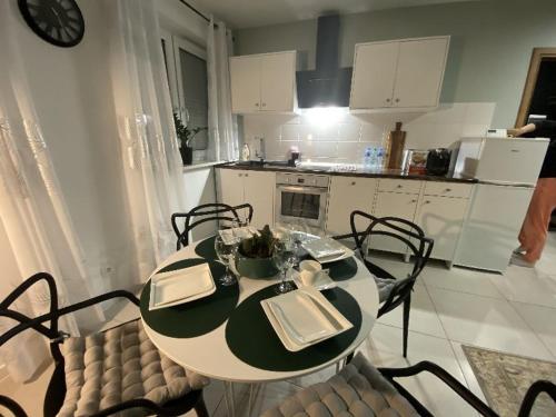 a kitchen with a table and chairs and a kitchen with a table and chairsktop at Apartament Błogi Sen III - komfortowy nocleg w spokojnej lokalizacji in Zabrze