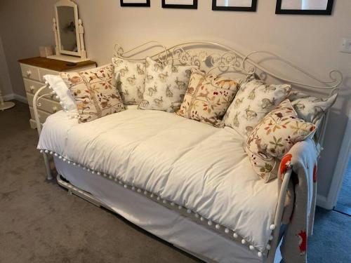 białe łóżko z poduszkami w pokoju w obiekcie Klara's House w mieście West Mersea