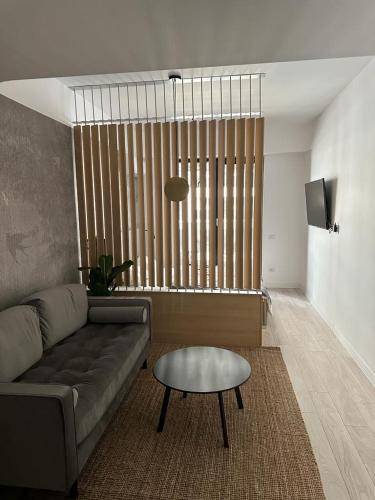 a living room with a couch and a table at Urban Flats in Bucharest