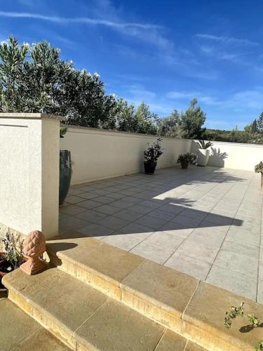 a patio with a fence and some plants at Casa Fumica Apartment in Palit