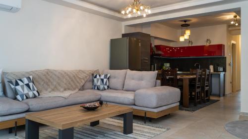 a living room with a couch and a table at Meteora Skyline by Meteora Residencies in Kalabaka