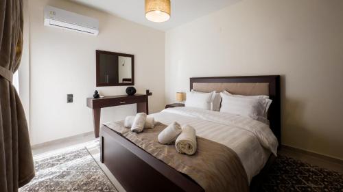 a bedroom with a large bed with towels on it at Meteora Skyline by Meteora Residencies in Kalabaka