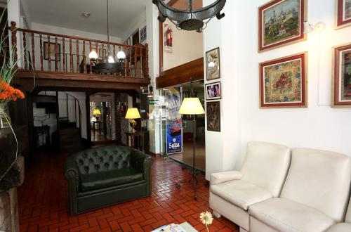 a living room with a couch and a chair at Hotel Regidor in Salta