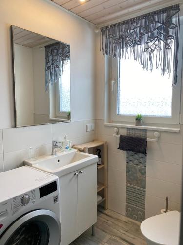 a bathroom with a washing machine and a sink at Penthouse in Kohila in Kohila