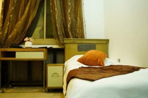 拉馬拉的住宿－ستوديوهات دانيال Daniel Studio，一间卧室配有一张床、一张桌子和一张四柱床。