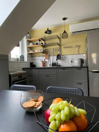 a bowl of fruit on a table in a kitchen at Penthouse in Kohila in Kohila