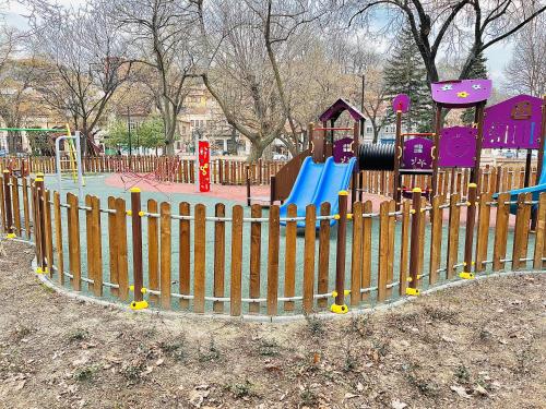 a playground in a park with a wooden fence at Old Town Stylish Flat in Center Plovdiv in Plovdiv