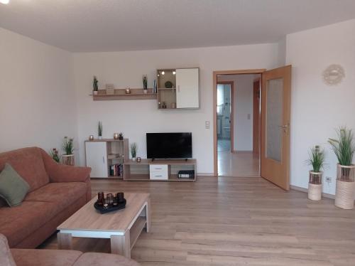 a living room with a couch and a table at Ferienwohnung Schneider in Ruhstorf