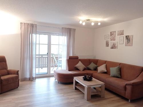 a living room with a couch and a table at Ferienwohnung Schneider in Ruhstorf