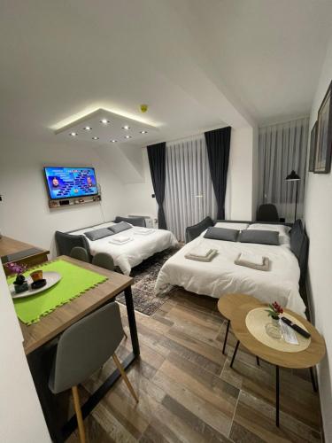 a hotel room with two beds and a table at Gencian resort in Kopaonik