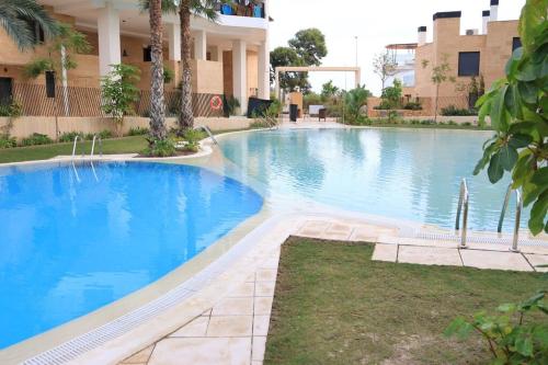 una grande piscina di fronte a un edificio di Apartamento Allonbay & SPA, Playa de El Torres a Villajoyosa