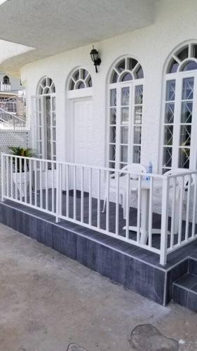 a white fence in front of a white house at Ridgeview Suites 1 to 3 in Kingston
