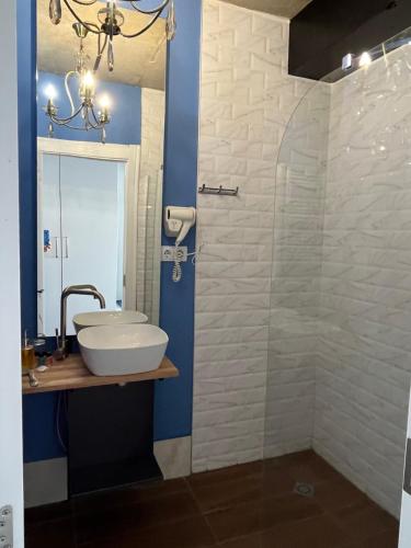 a bathroom with a sink and a glass shower at Twins apartment deluxe, new gudauri in Gudauri