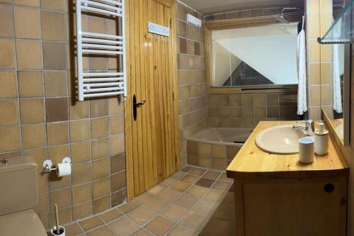 a bathroom with a sink and a tub at LF LEVEL Sierra Nevada Duplex in Sierra Nevada
