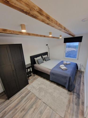 a bedroom with a large bed and a window at R&J Guesthouse Apartment in Grindavík