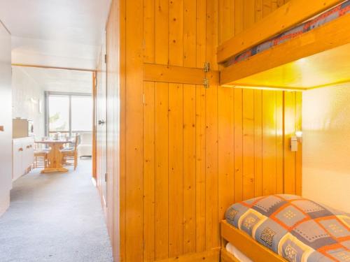 a bedroom with a bunk bed and a dining room at Studio Les Arcs 1800, 1 pièce, 5 personnes - FR-1-346-425 in Arc 1800