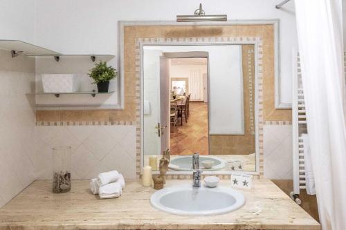 a bathroom with a sink and a mirror at Terzo Campanello - Terrazza nel Centro Storico in Lecce