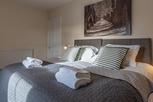 a bedroom with two beds with towels on the bed at 3 bedroom home sleeps 5 close to Chester City Centre welcomes couples, small groups, families and contractors in Chester