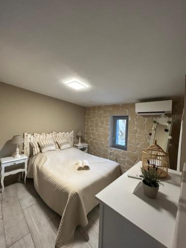 a bedroom with a large bed and a table at Location Bonnieux Provence in Bonnieux