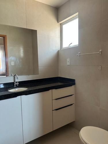 a bathroom with a sink and a toilet at Casa Praia dos Carneiros in Tamandaré