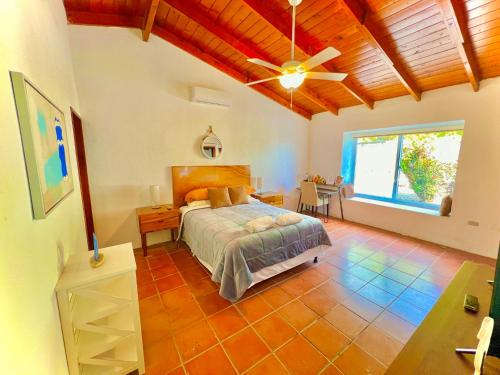 sypialnia z łóżkiem i wentylatorem sufitowym w obiekcie Casa Mahi w mieście El Progreso