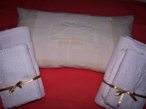 two white towels with bows on a bed at Kastorio-Villy's Guest House in Kastórion