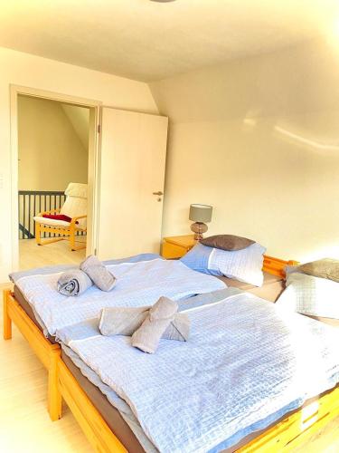 a bedroom with a large bed with towels on it at Sehr beliebt! Ferienhaus zur Donau in Herbertingen