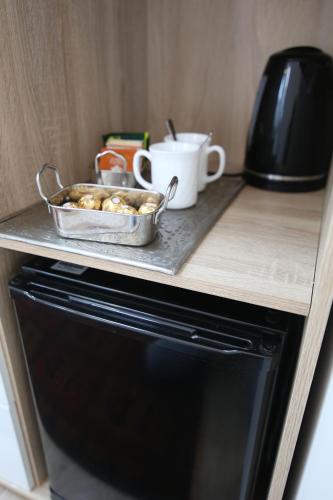 a tray of food sitting on top of a microwave at Hotel Vila Katrca in Ljubljana