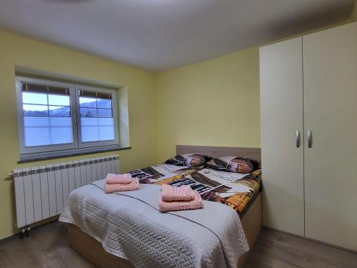 a bedroom with two beds and a window at Apartma Melita in Kobarid