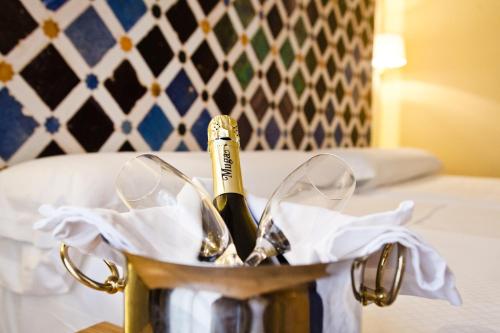 a bottle of champagne in a bucket on a table at Hotel Comfort Dauro 2 in Granada
