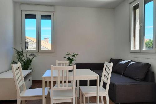 a living room with a table and chairs and a couch at Casa rural en San Vicente de O Grove in O Grove