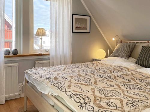 a bedroom with a large bed in front of a window at Holiday home MARSTRAND III in Marstrand