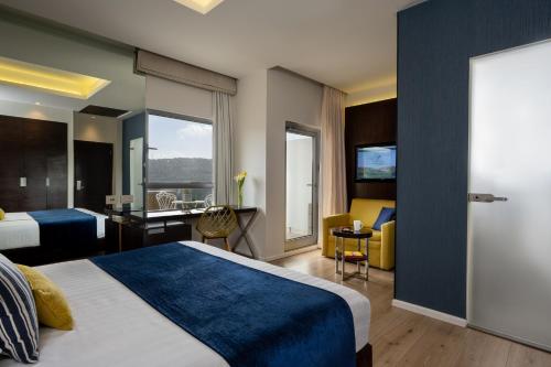 a hotel room with a bed and a desk at Hotel Yehuda in Jerusalem