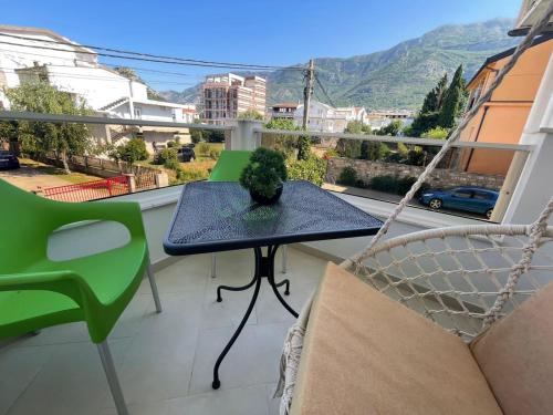 a table and chairs on a balcony with a view at Apartments Pericic in Sutomore