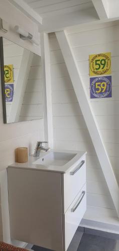a bathroom with a sink and a staircase at Maison de famille in Saint-Louis