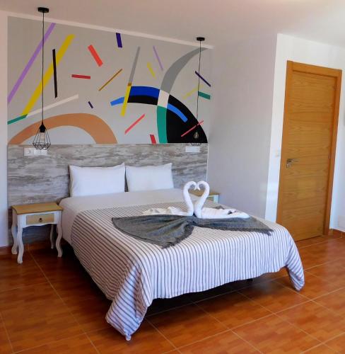 a bedroom with a bed with a swan on it at Chabela's Suites in La Lajita