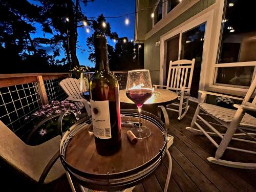 a bottle of wine sitting on a table with a glass at Coastal Retreat Cambria 2 King 1 Queen Bed Fireplace Wi-Fi Free Parking in Cambria