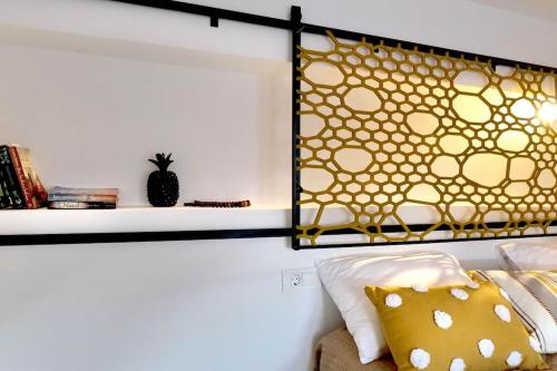 a bedroom with a bed with yellow pillows and a shelf at Cocoloco apartment in Kalymnos