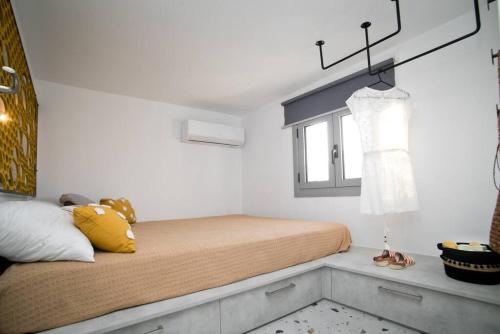 a bedroom with a bed and a window at Cocoloco apartment in Kalymnos