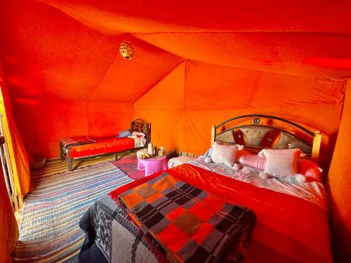 a bedroom with a bed in a tent at Bivouac Luna in Mhamid