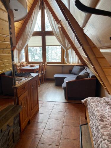 ザコパネにあるWilla Góralskie Spanieのベッド、ソファ、テーブルが備わる客室です。