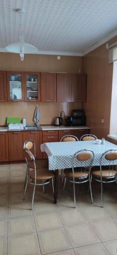 a kitchen with a table and chairs in a kitchen at Noclegi Arka in Osiek