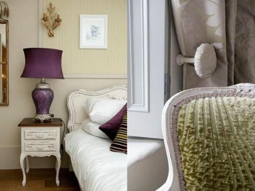 a bedroom with a bed and a table with a lamp at No.64 at the Joiners in West Malling