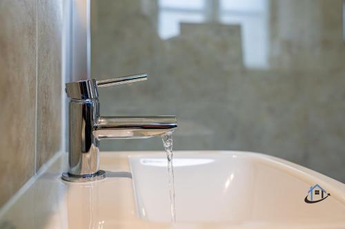 a sink with water coming out of a faucet at The Old Plough, mix of 1 bed and 3 bed units, rustic charm, super king bed or twins, en-suite, secure parking in Caldecott