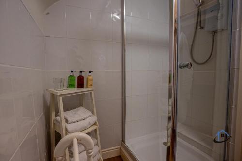 a bathroom with a shower and a glass door shower at The Old Plough, mix of 1 bed and 3 bed units, rustic charm, super king bed or twins, en-suite, secure parking in Caldecott